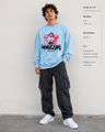Person wearing a light blue sweatshirt with a graphic design and text, standing against a plain background.