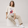 Person wearing a 'Chill on the Street' t-shirt sitting on a white stool against a plain background