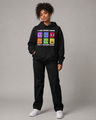 Person wearing a black hoodie with colorful graphic design on a gray background
