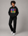 Person wearing a black hoodie with colorful graphic design on a gray background