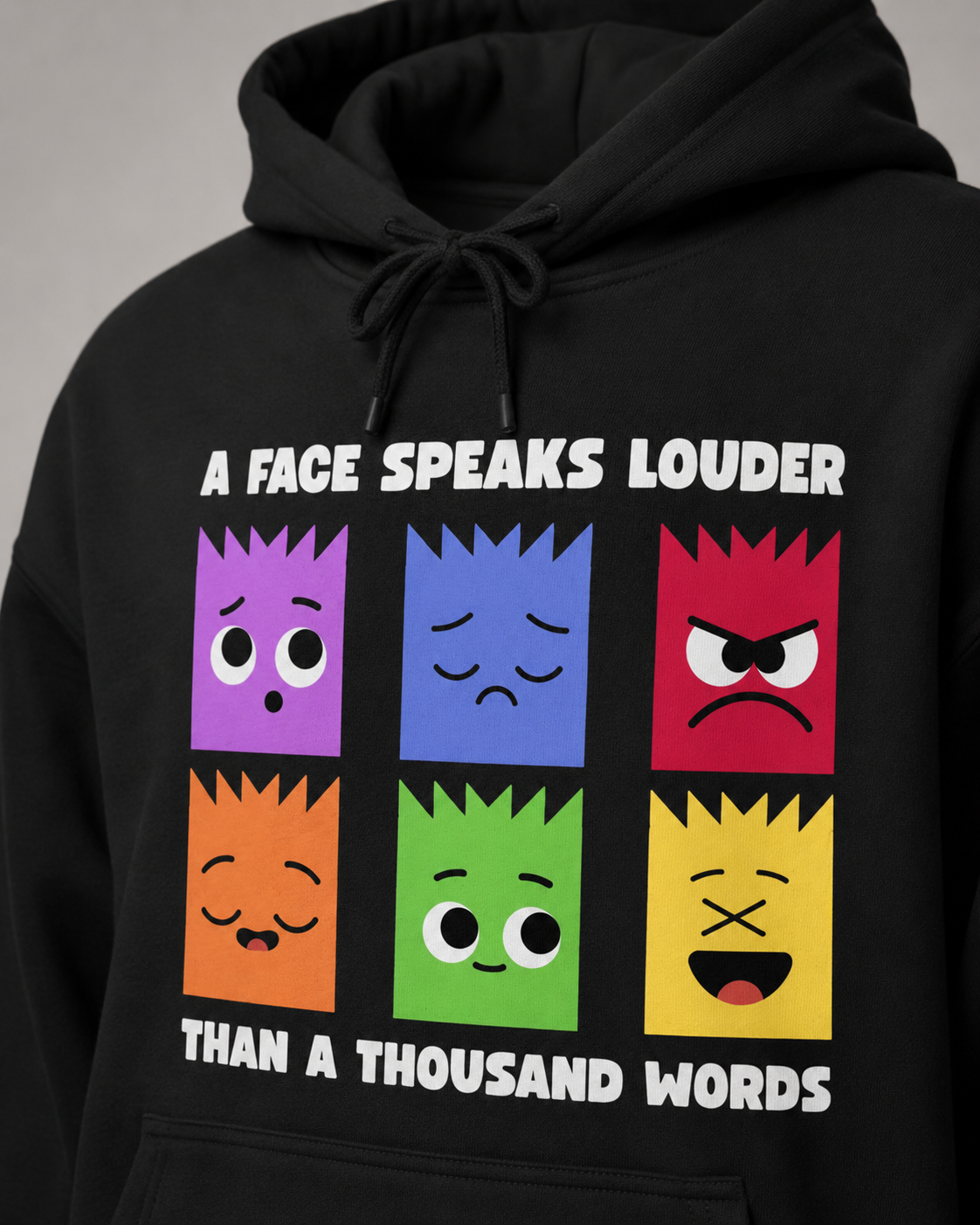 Black hoodie with colorful face表情 designs and text on a gray background