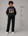 Person wearing a black hoodie with colorful graphic design on a gray background