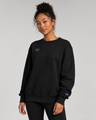 Person wearing a black sweatshirt with a logo on a gray background