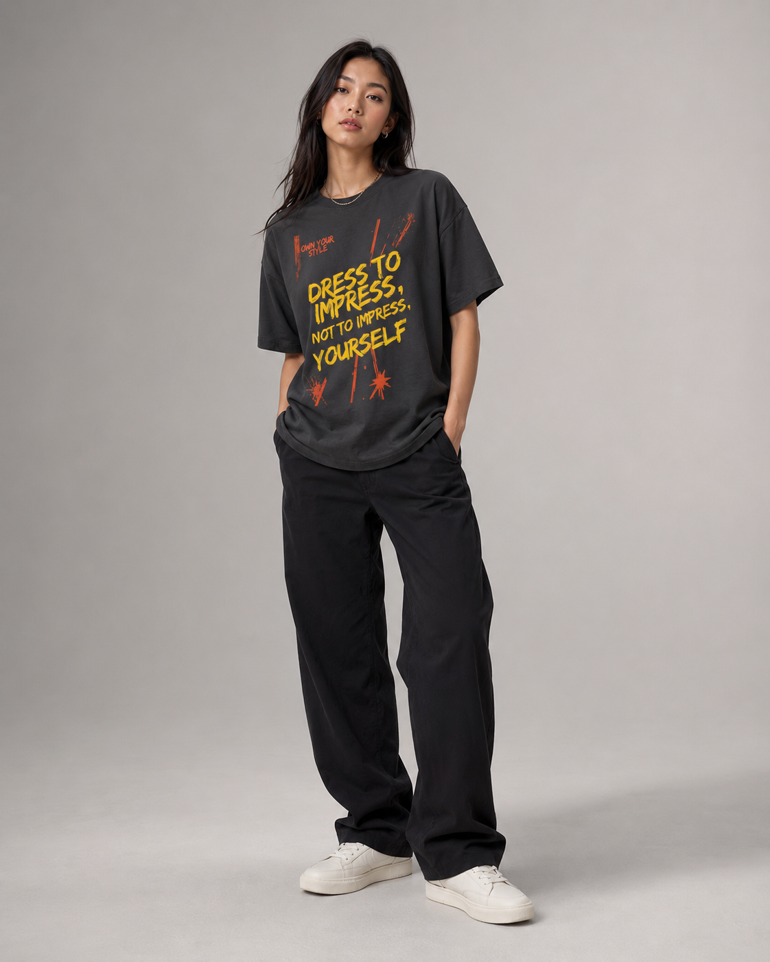 Person wearing a black t-shirt with a motivational quote on a plain background