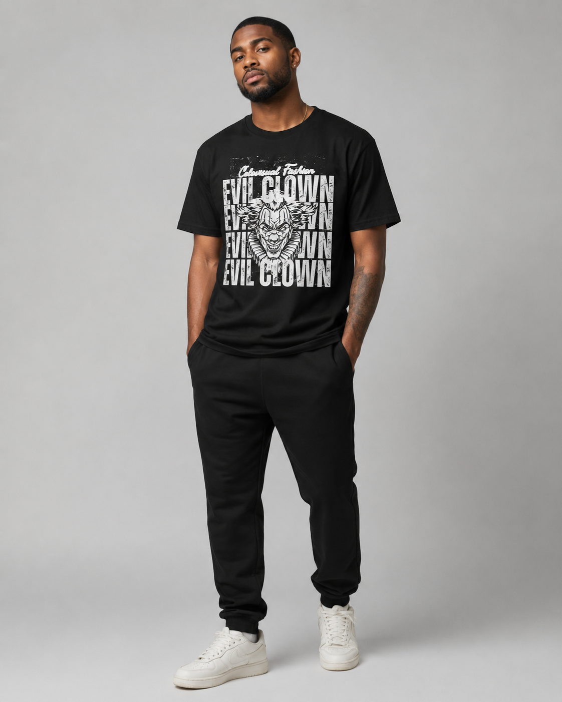 Man wearing a black t-shirt with graphic design and text on a gray background