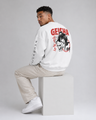 Person wearing a white sweatshirt with 'Geisha' design and text, sitting on a white block against a gray background.