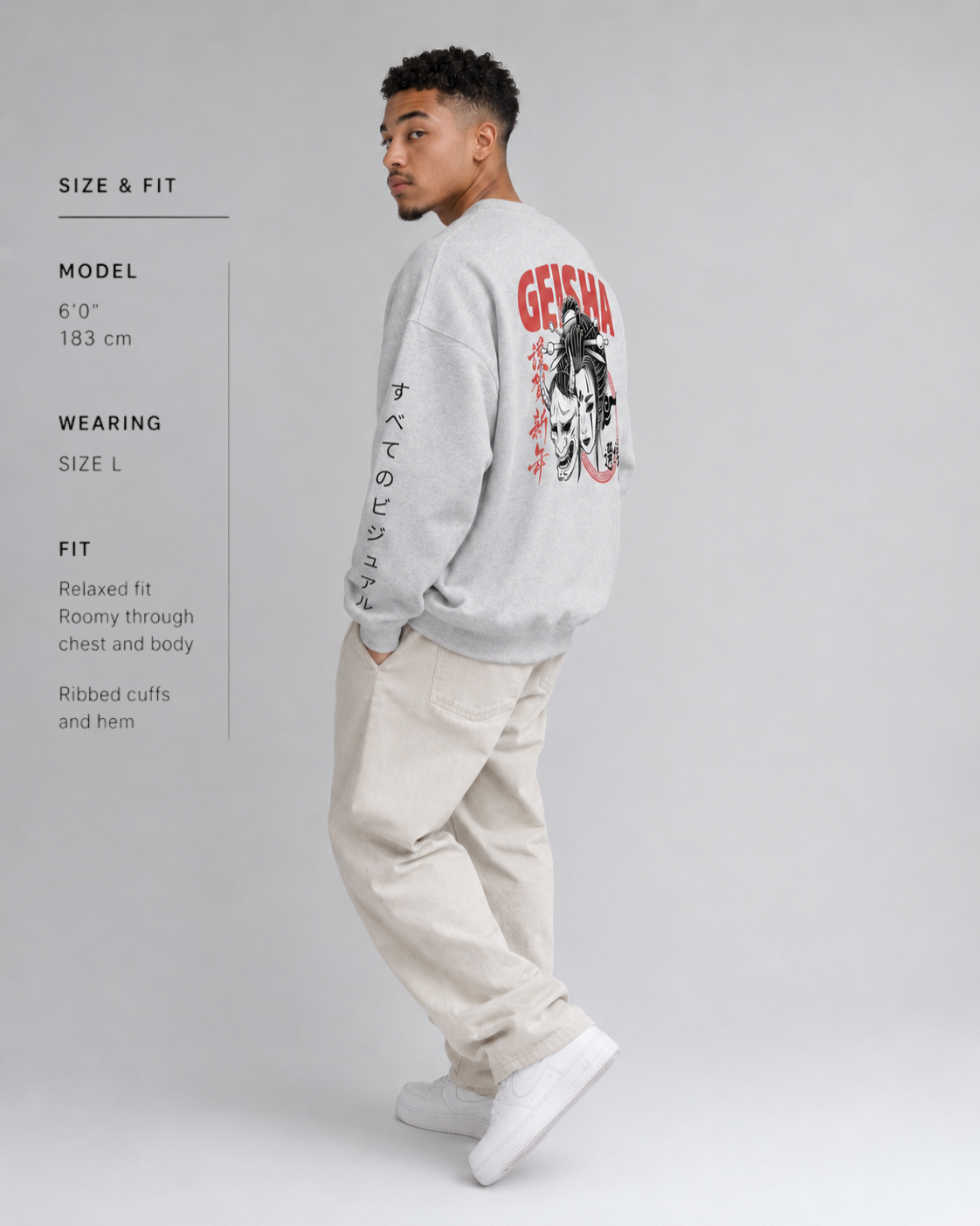 Man wearing a gray sweatshirt with red and white graphics on a gray background