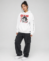 Person wearing a white hoodie with graphic design and text, standing against a plain background