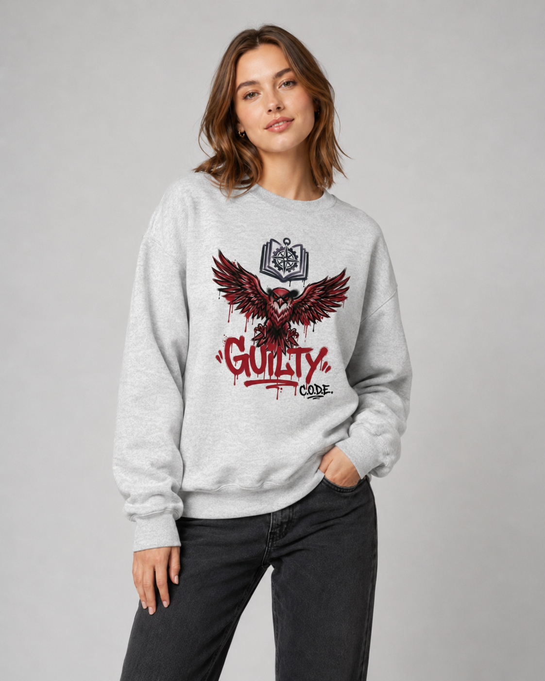 Person wearing a gray sweatshirt with a graphic design and text on a plain background