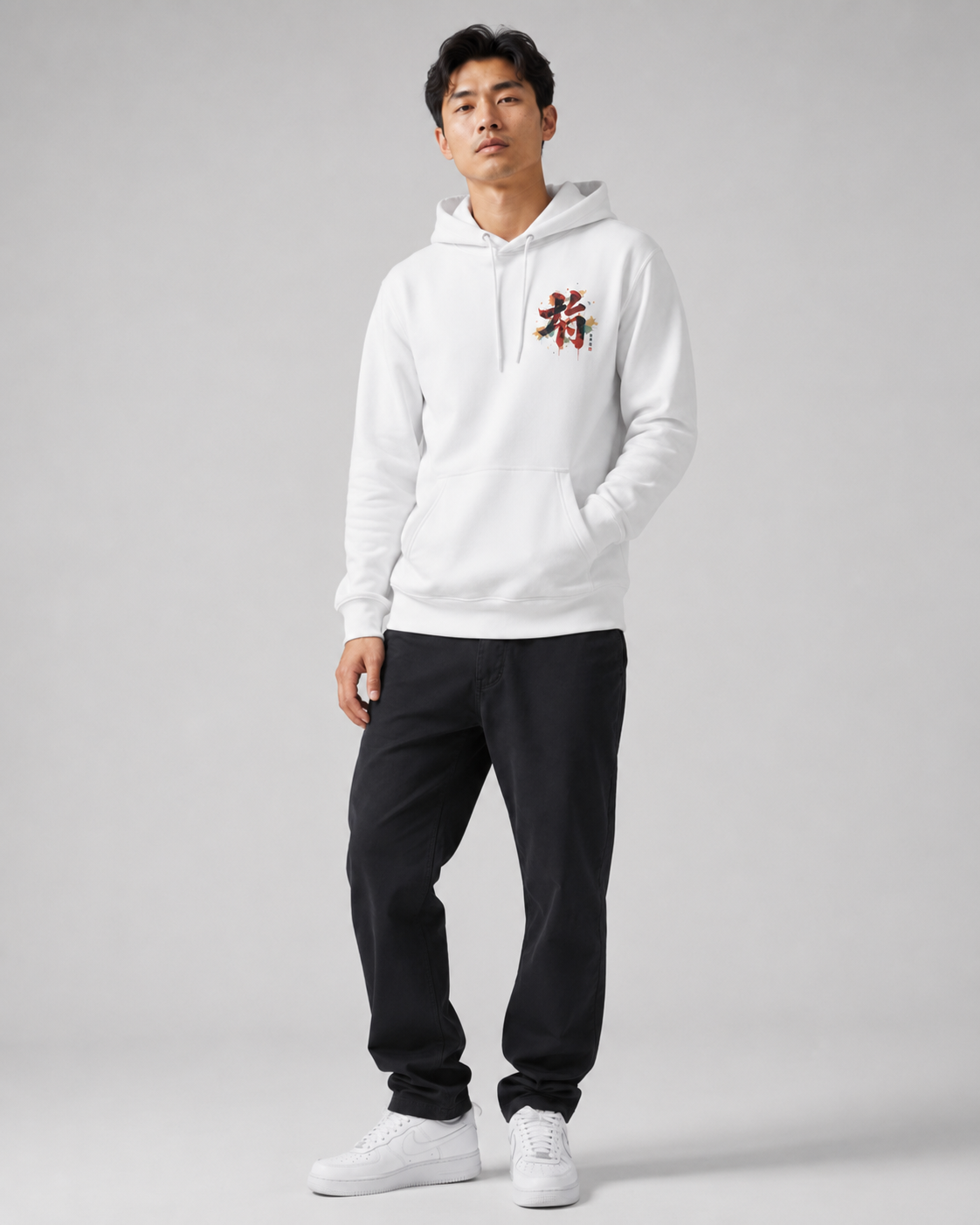 Person wearing a white hoodie with red text and black pants on a gray background