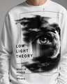 White sweatshirt with eye graphic and text 'Low Light Theory' worn by a person