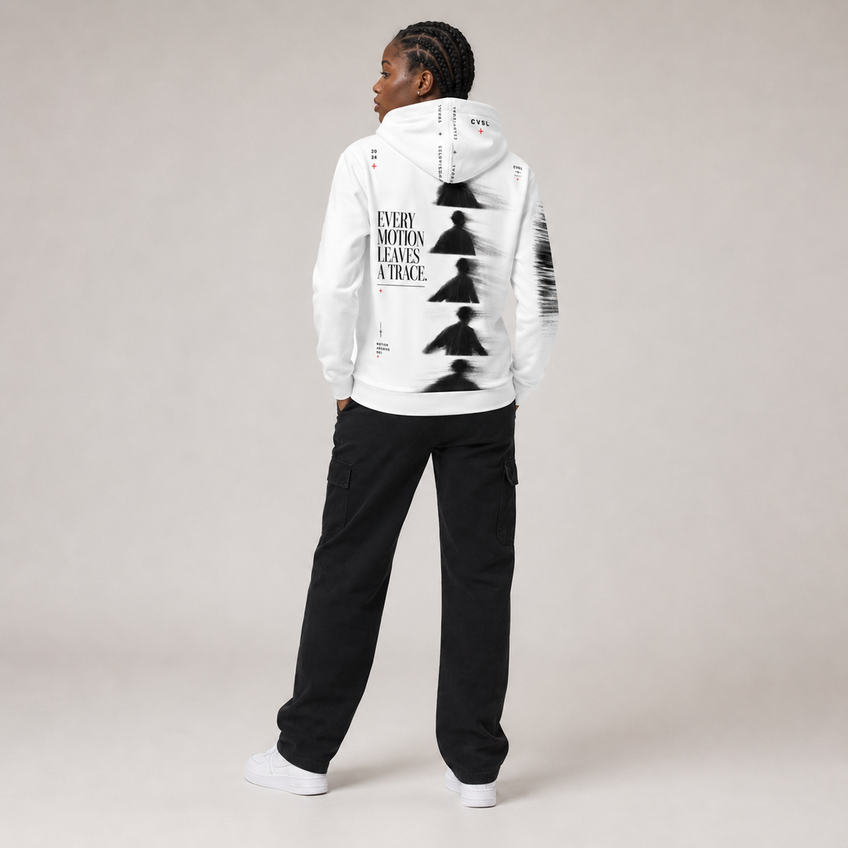 Person wearing a white hoodie with black graphics and text on the back, standing against a plain background.