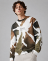Man wearing a camouflage-patterned sweater on a gray background