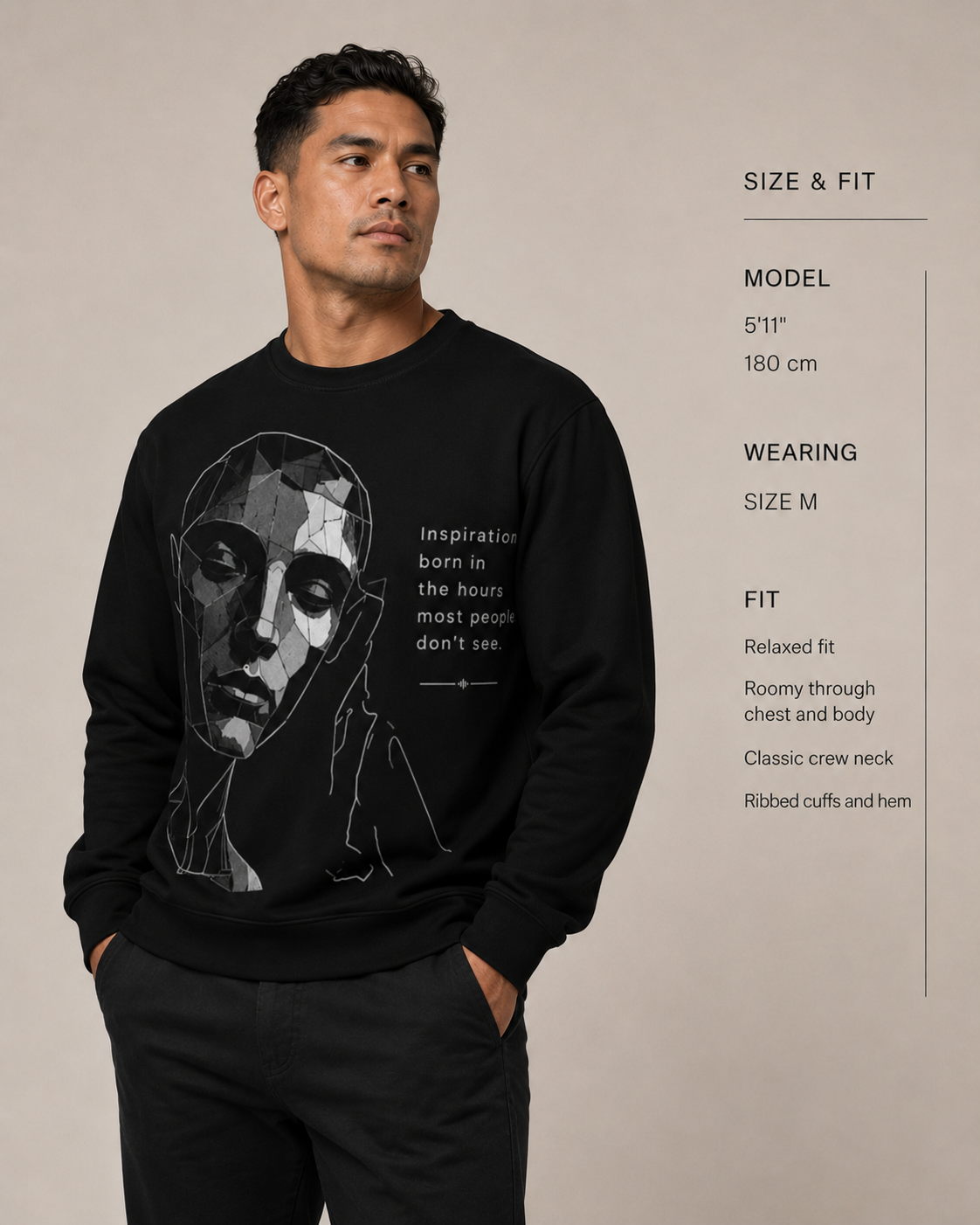 Man wearing a black sweatshirt with a graphic design and text, standing against a beige background.