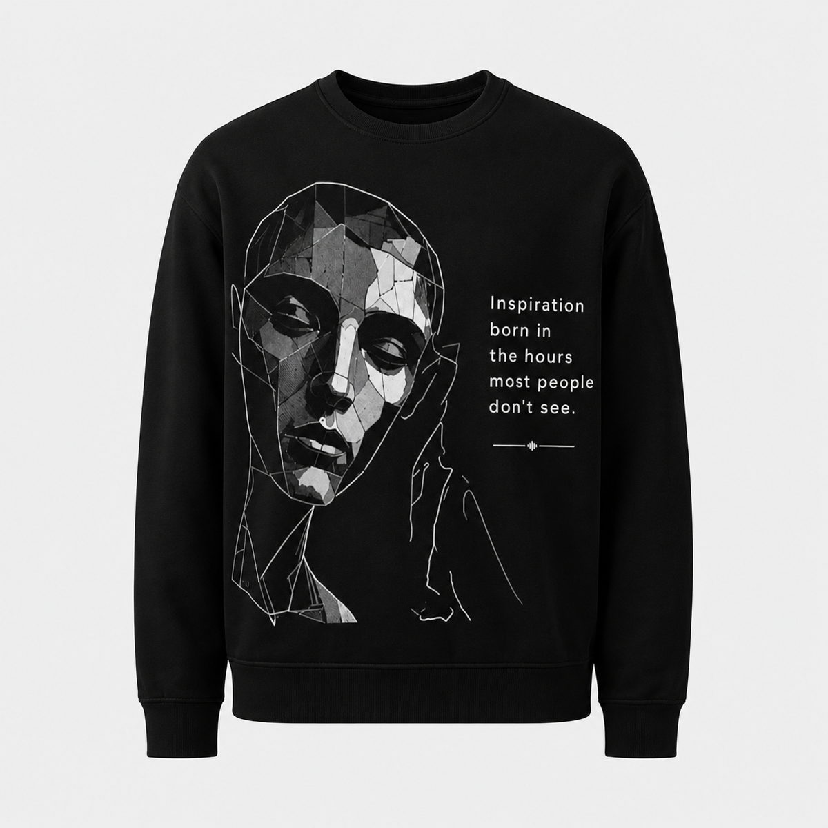 Black sweatshirt with geometric face design and motivational quote on a light gray background