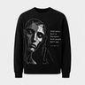 Black sweatshirt with geometric face design and motivational quote on a light gray background