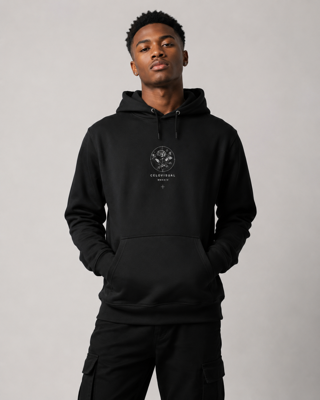 Person wearing a black hoodie with a logo on a gray background