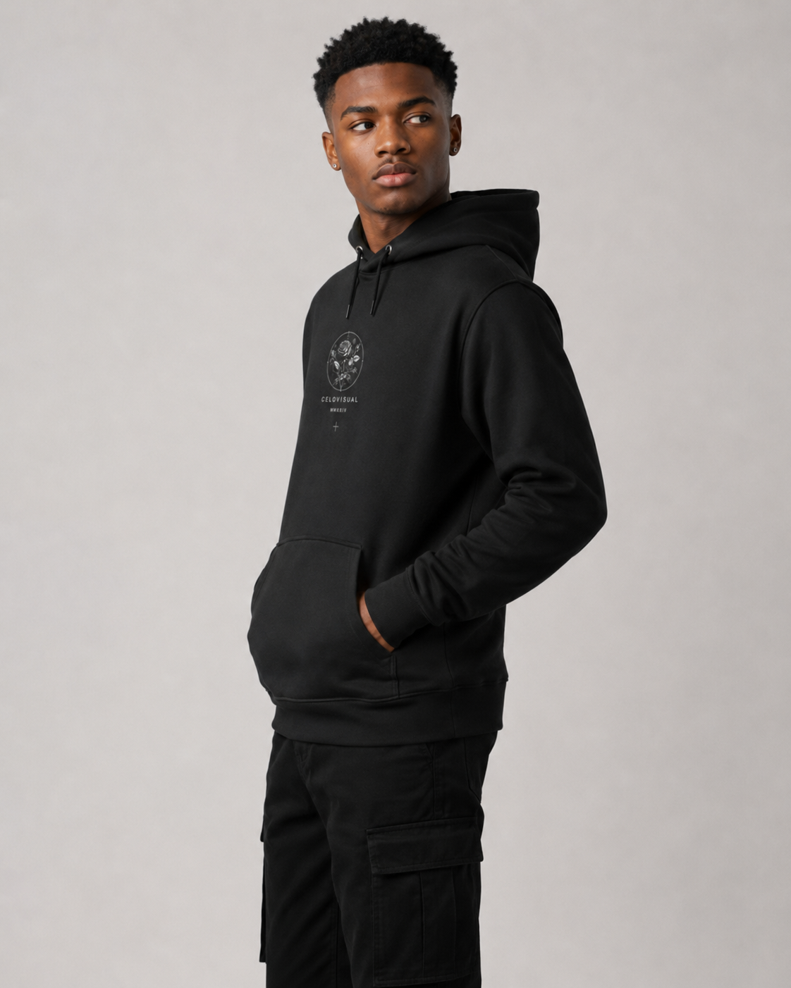 Person wearing a black hoodie with a logo on a gray background