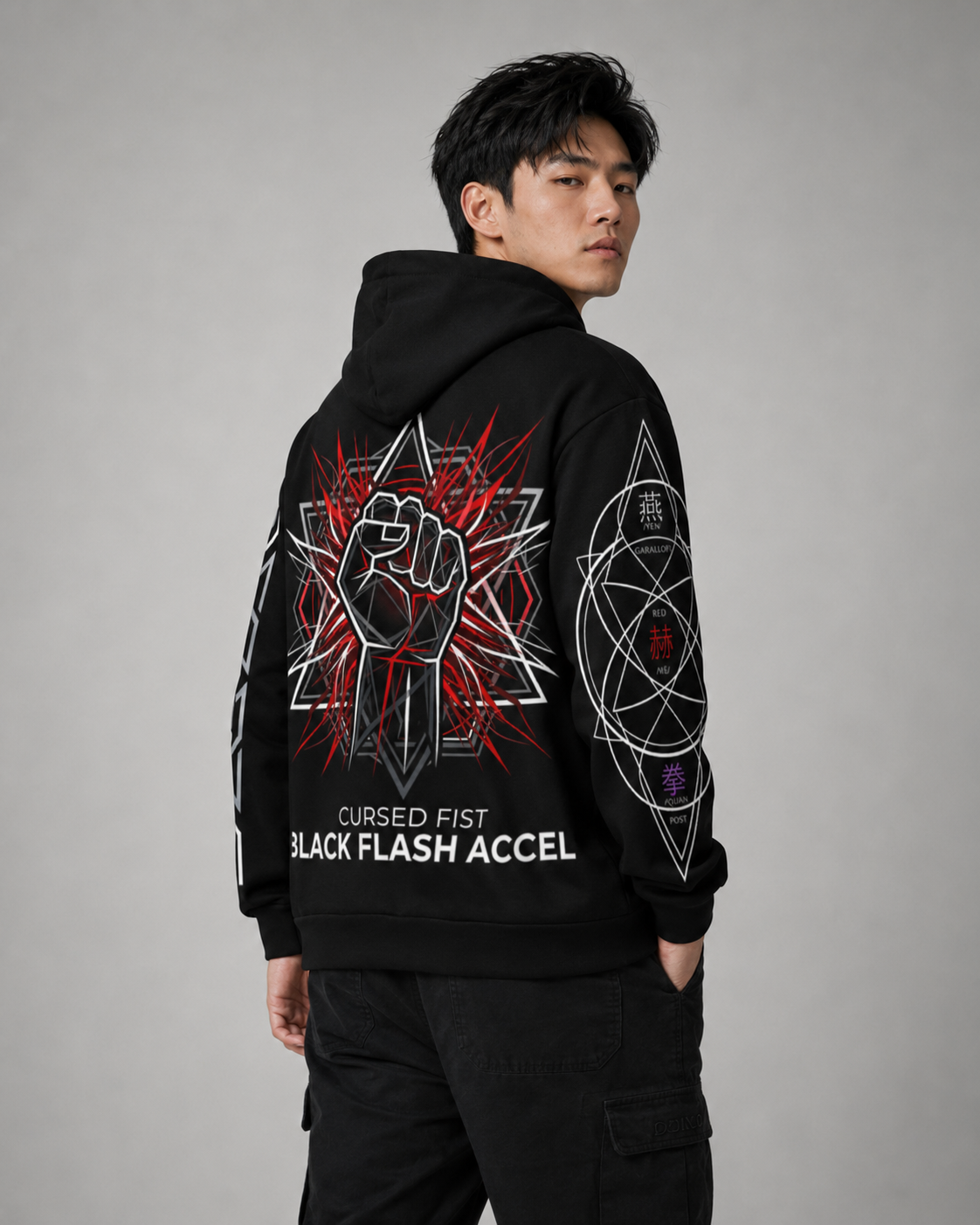 Person wearing a black hoodie with graphic designs and text on a gray background