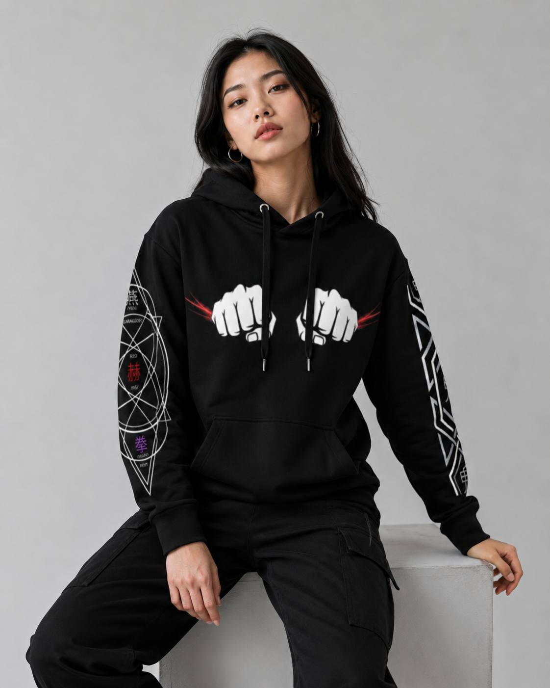 Person wearing a black hoodie with white graphics on a gray background