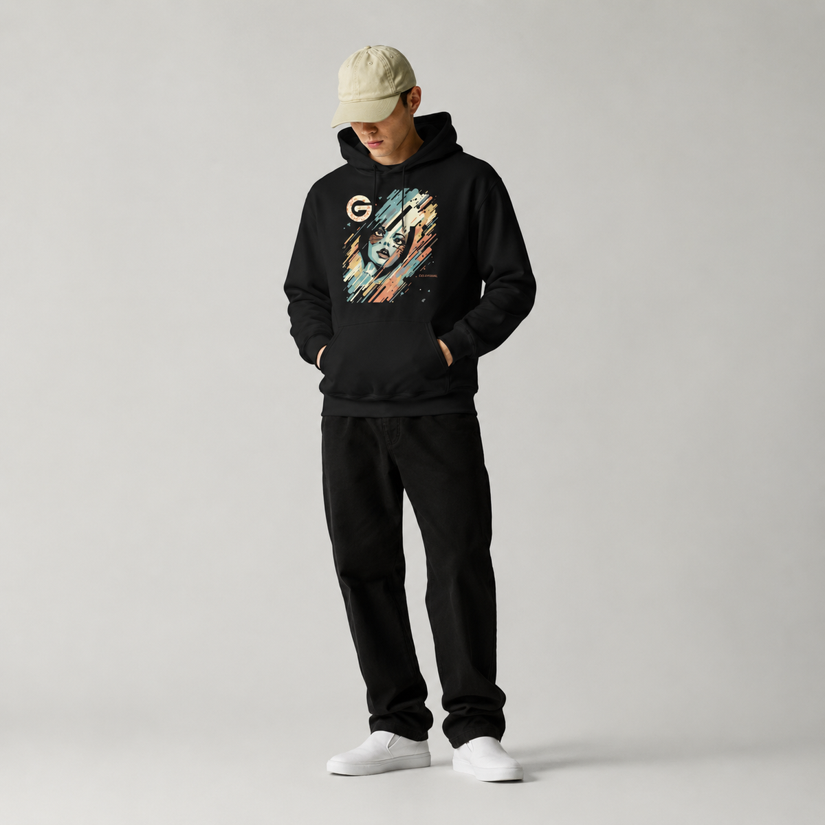 Person wearing a black hoodie with a colorful graphic and black pants on a light gray background