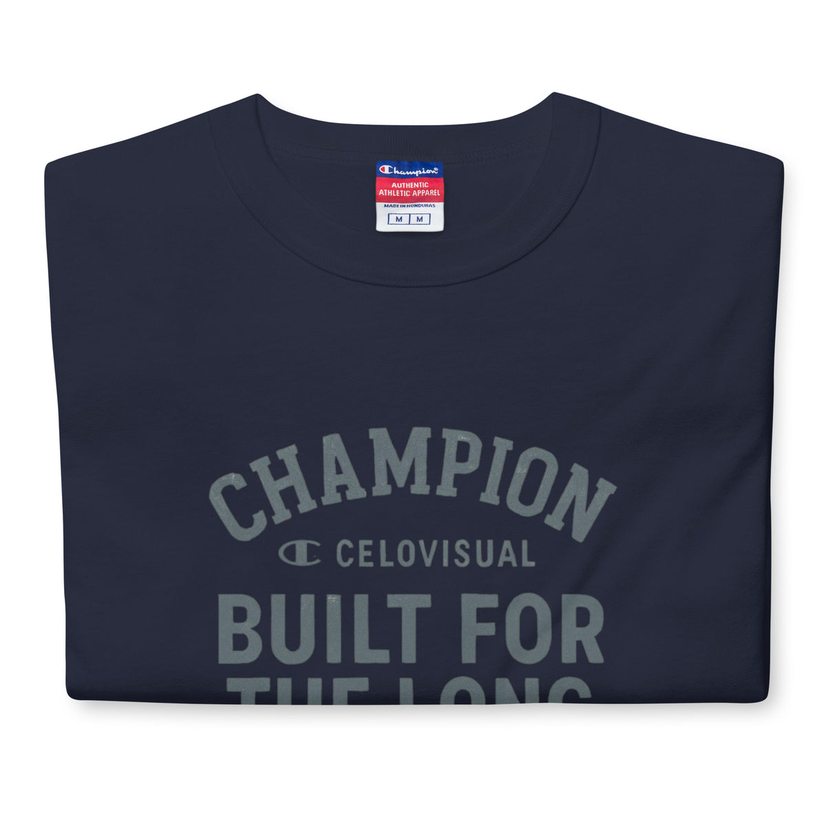 Folded navy blue t-shirt with Champion logo and text on a white background