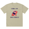 Beige t-shirt with a graphic of a person sitting and text 'Chill on the Street' on a white background